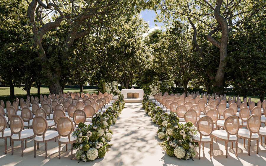 Ceremonia en jardín con sillas blancas y pasillo entre árboles