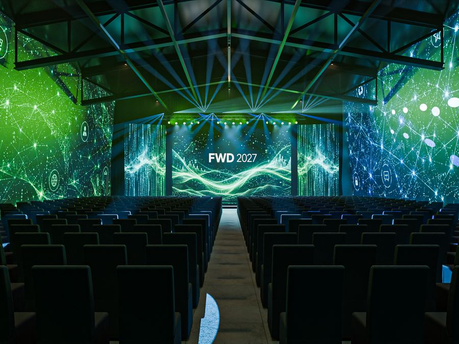 Auditorio con pantallas de luz y haces láser sobre el escenario