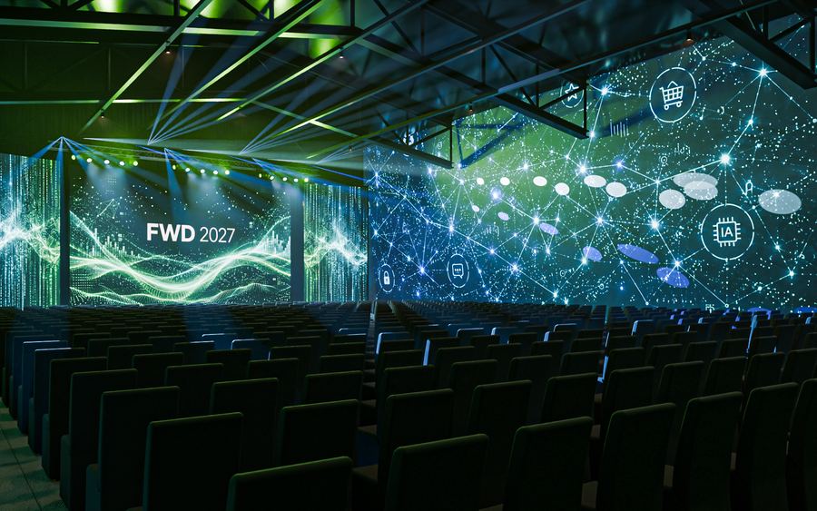 Auditorio panorámico envuelto en pantallas de luz verde y azul