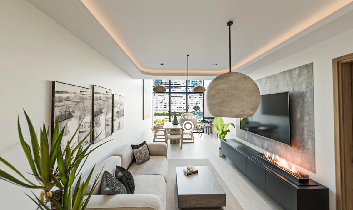 Modern living room with beige sofa, hanging round pendant light, wall-mounted TV, and decorative plants overlooking city views