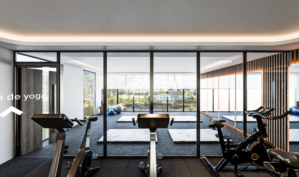 Modern gym with exercise equipment, floor-to-ceiling windows overlooking cityscape, and contemporary interior design with warm lighting
